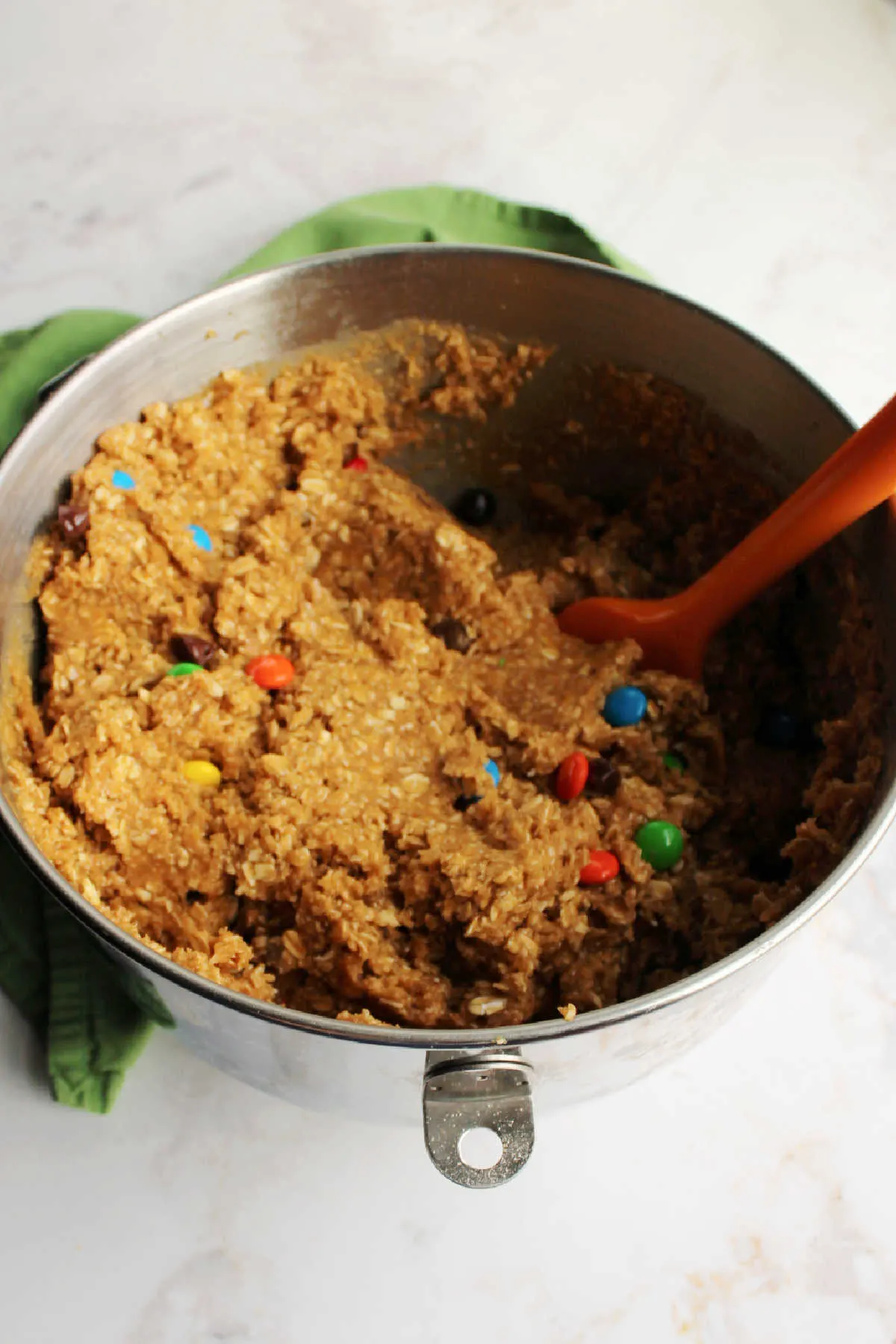 Large mixing bowl filled with peanut butter and oatmeal cookie dough.