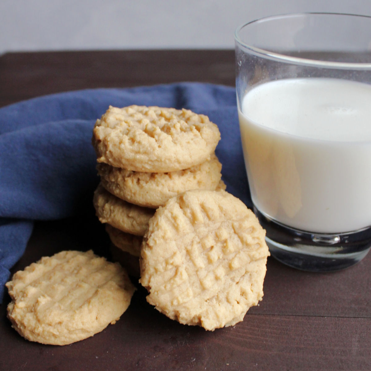 pile of peanut butter cookies and glass of milk