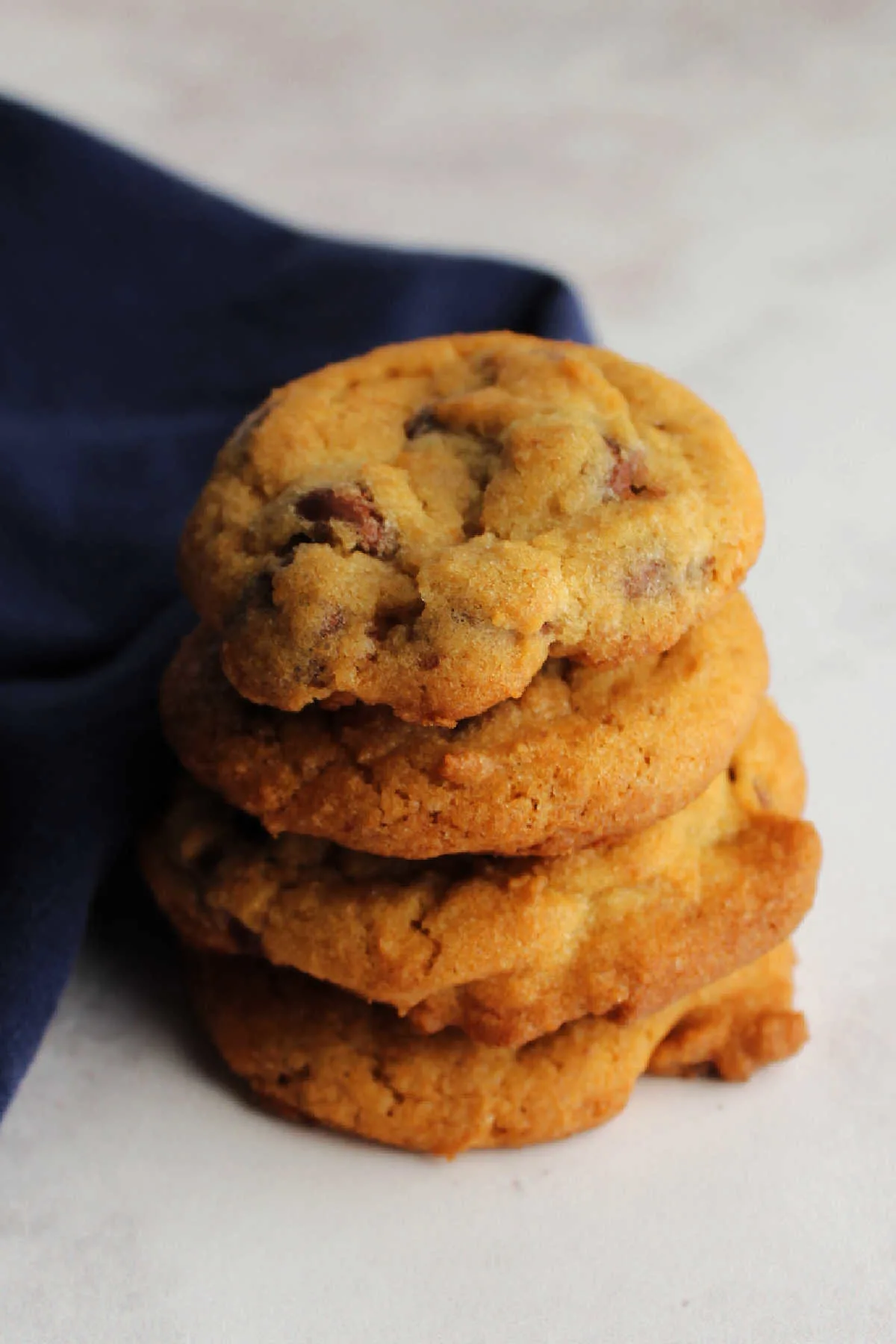Stack of golden brown chocolate chip cookies ready to eat.