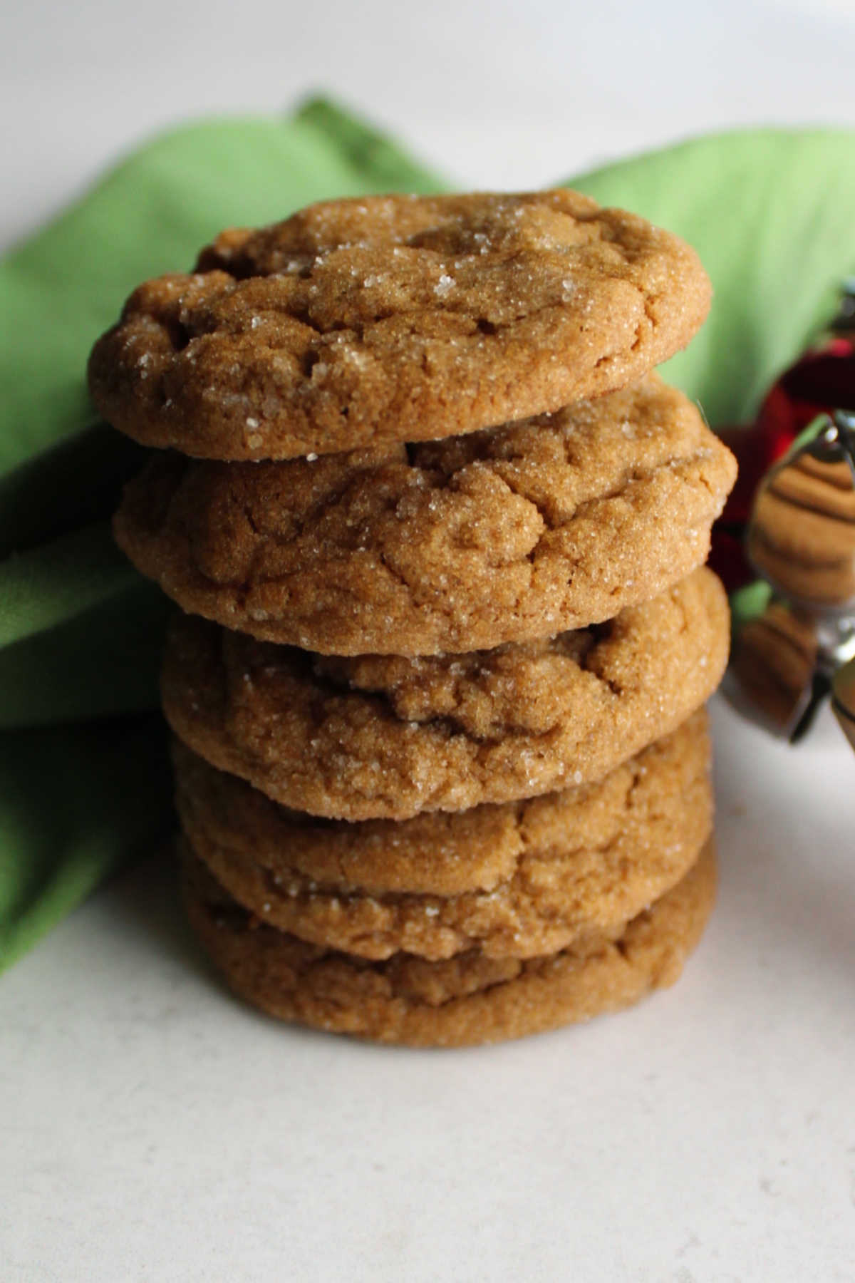 Stack of crinkly looking ginger molasses cookies ready to eat. 