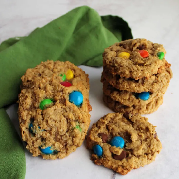 Stack of peanut butter monster cookies with oatmeal, chocolate chips and m&ms.