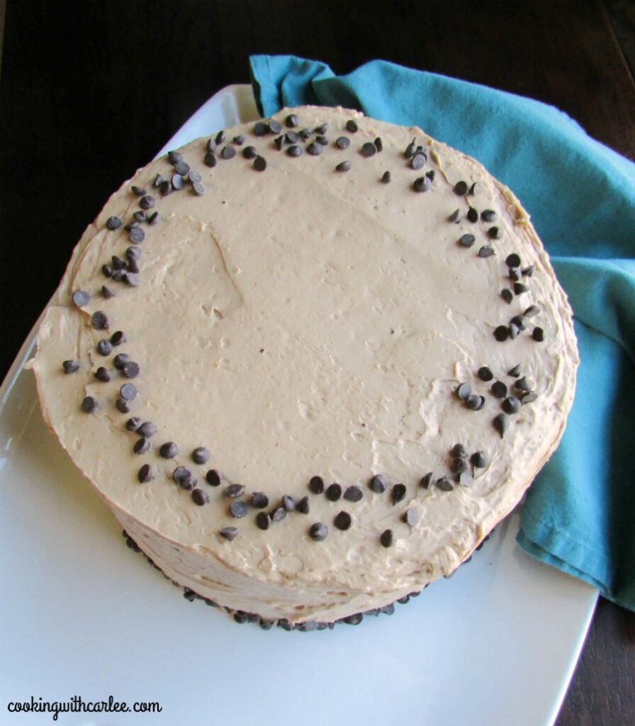 looking down on round cake with chocolate french buttercream and mini chocolate chips on top.