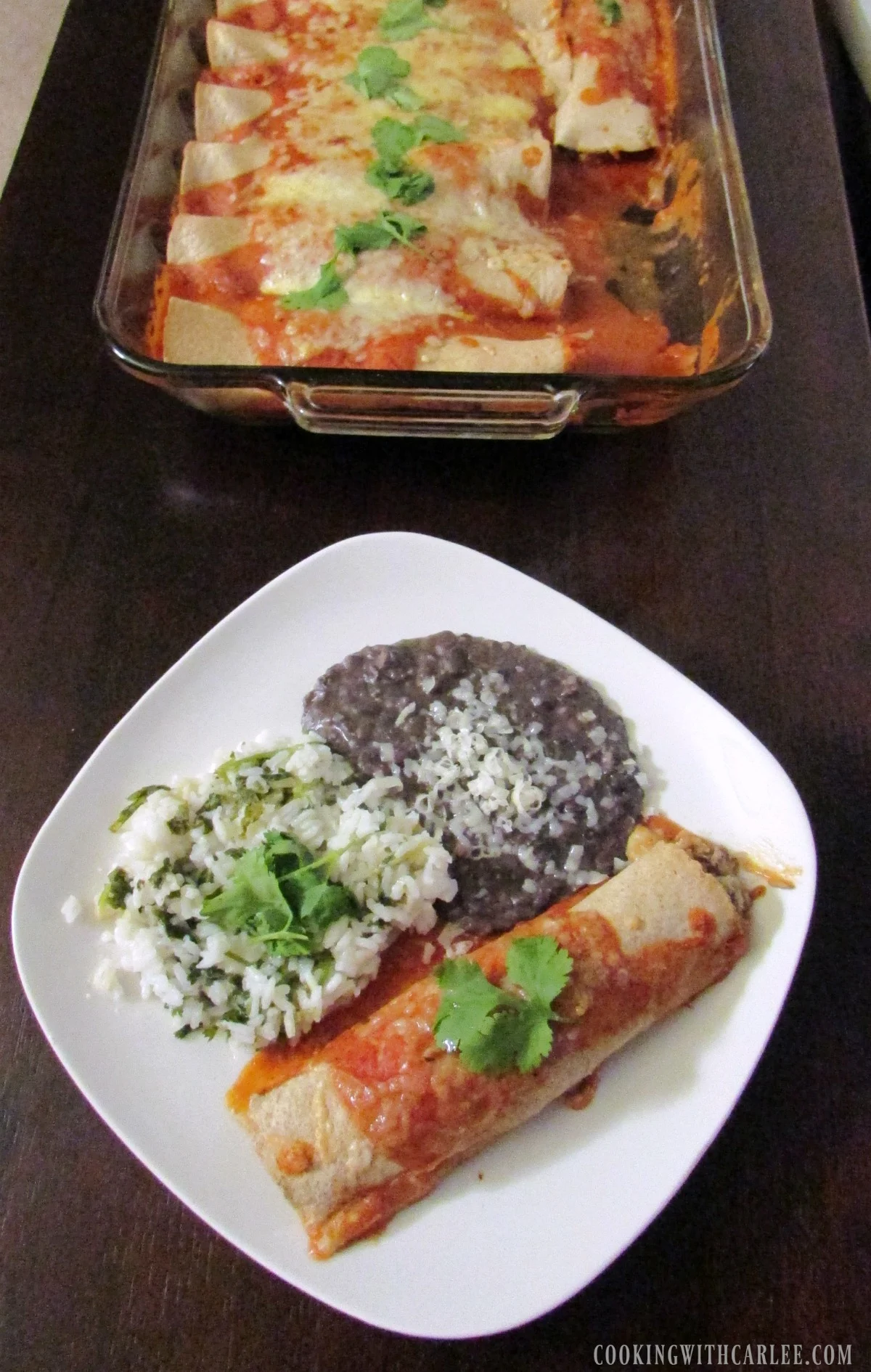 enchilada dinner in front of pan of remaining panful.