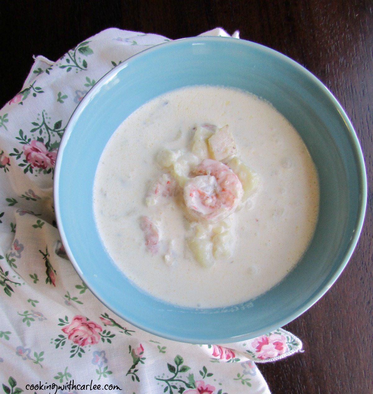 Bowl of creamy seafood chowder with shrimp and fish, ready to eat. 