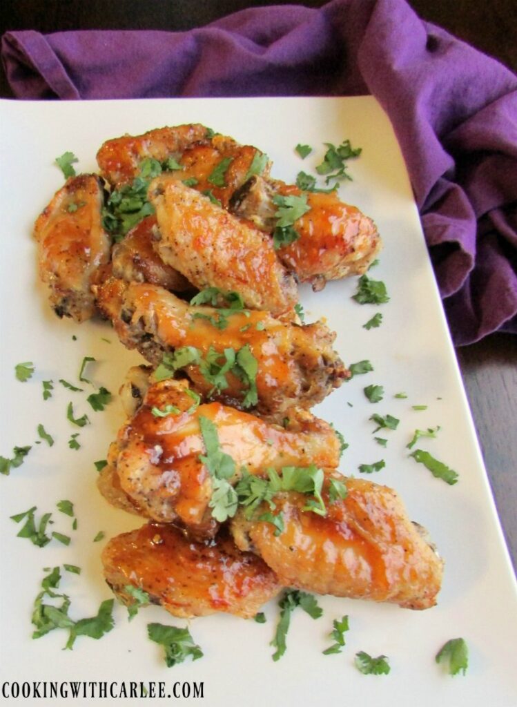 platter of chicken wings glazed in peach habanero sauce.