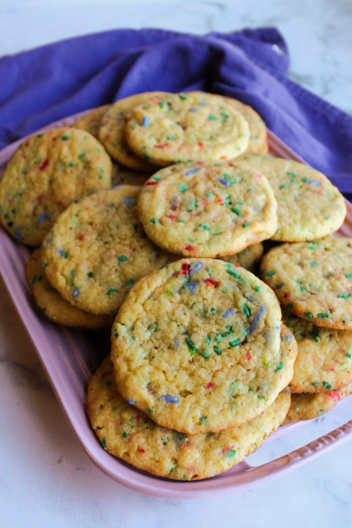 Platter filled with vanilla cake mix cookies with sprinkles baked inside. 
