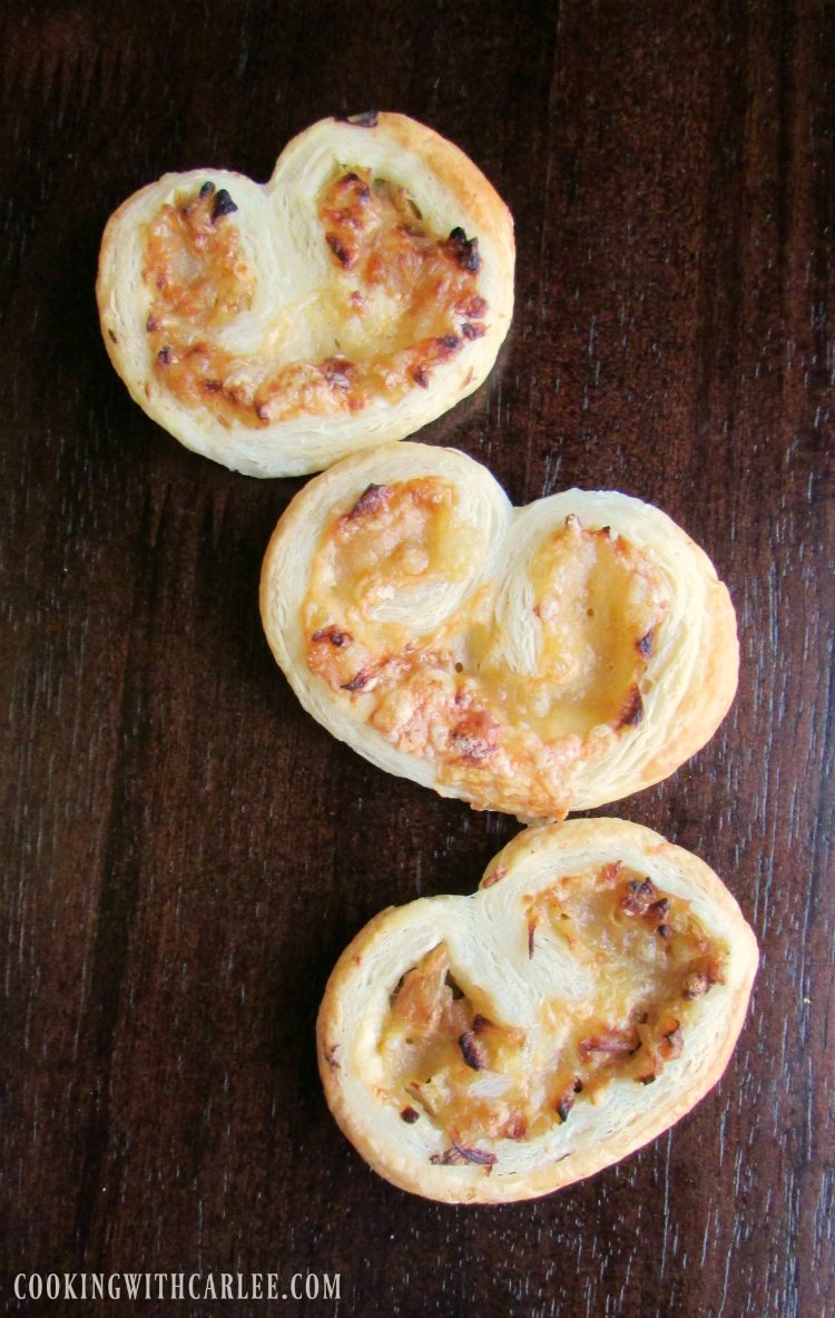 Golden french onion palmiers with cheese in the middle.