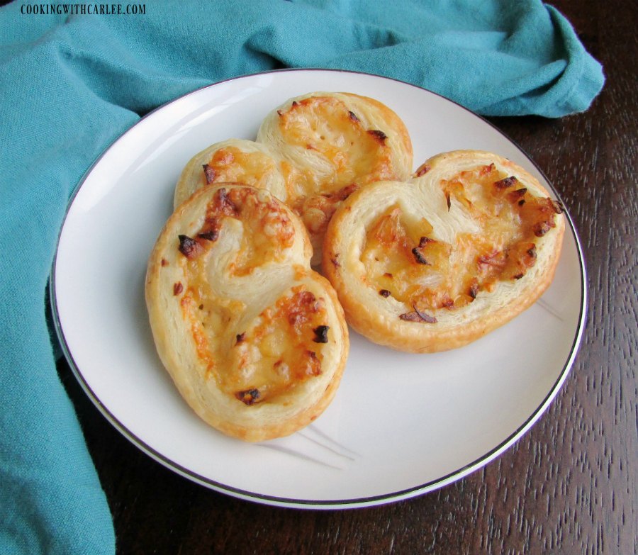 Plate full of cheesy french onion appetizer pastries.