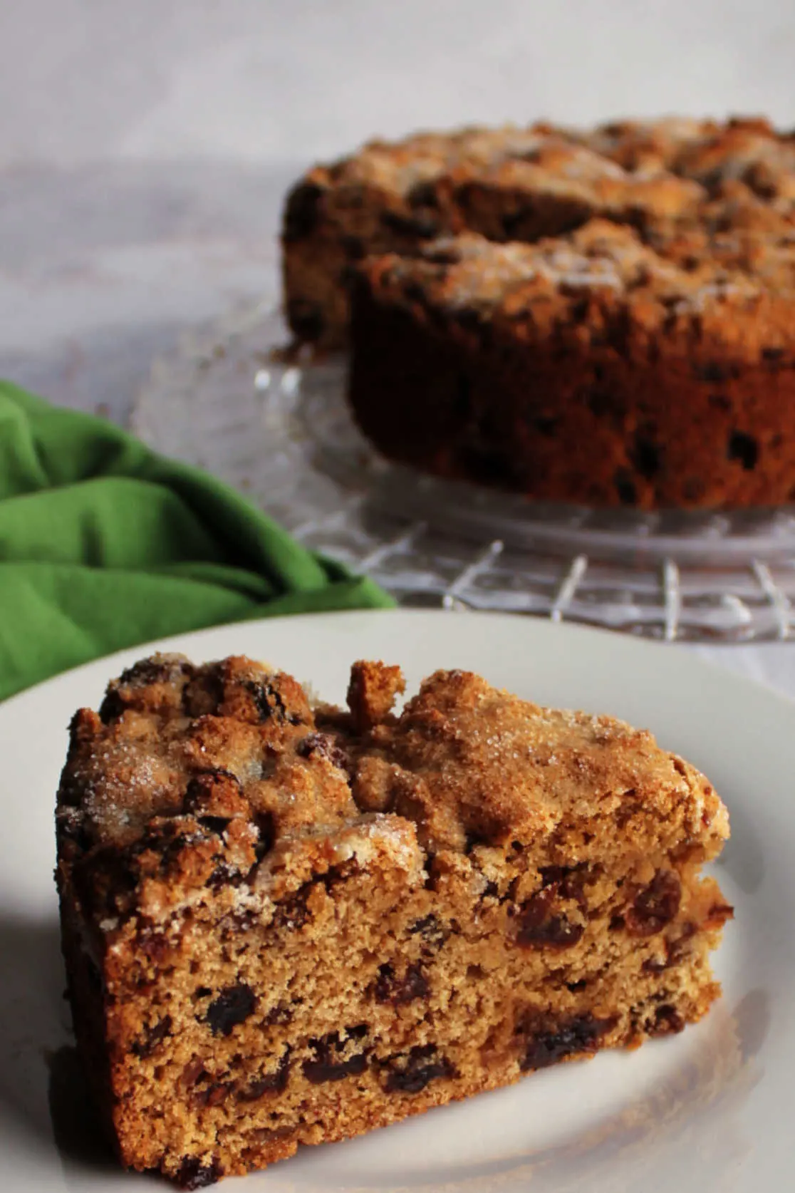 Close slice of Irish tea brack with soft brown bready interior dotted with loads of plumped up raisins and dates.