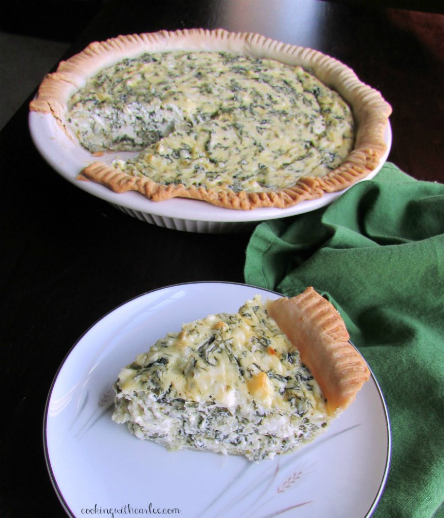 slice of spinach pie served with remaining pie in background