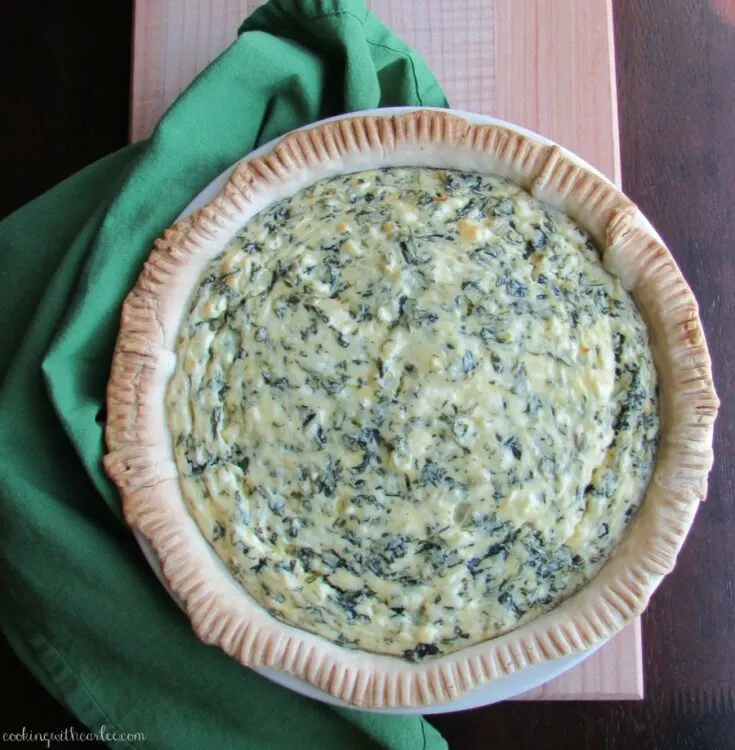 whole creamy cheese and spinach pie, ready to eat.