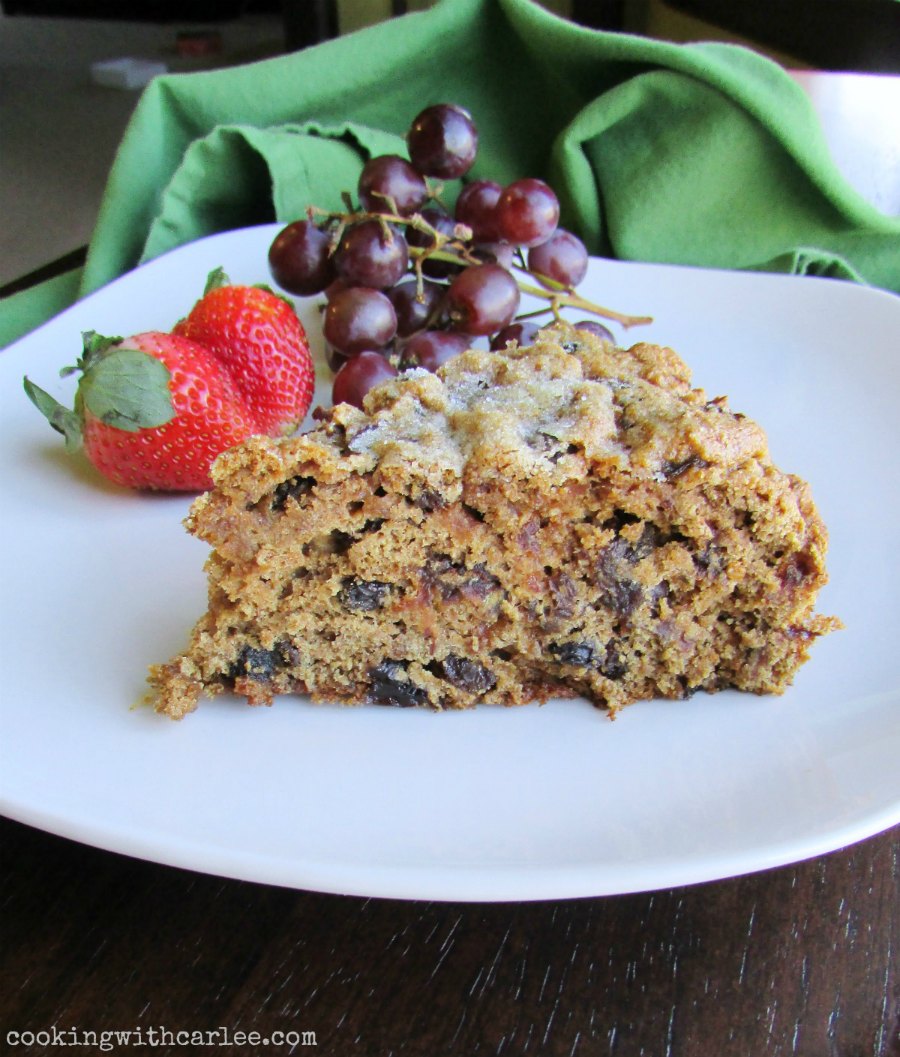 slice of raisin and date filled Irish tea brack on plate with grapes and strawberries.
