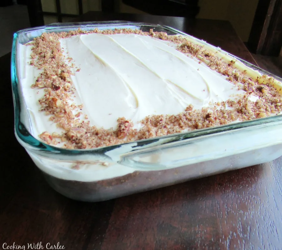 Pan of carrot cake with cream cheese frosting.