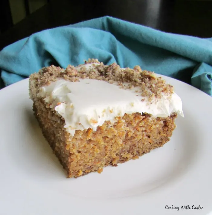 Piece of carrot cake topped with cream cheese frosting.