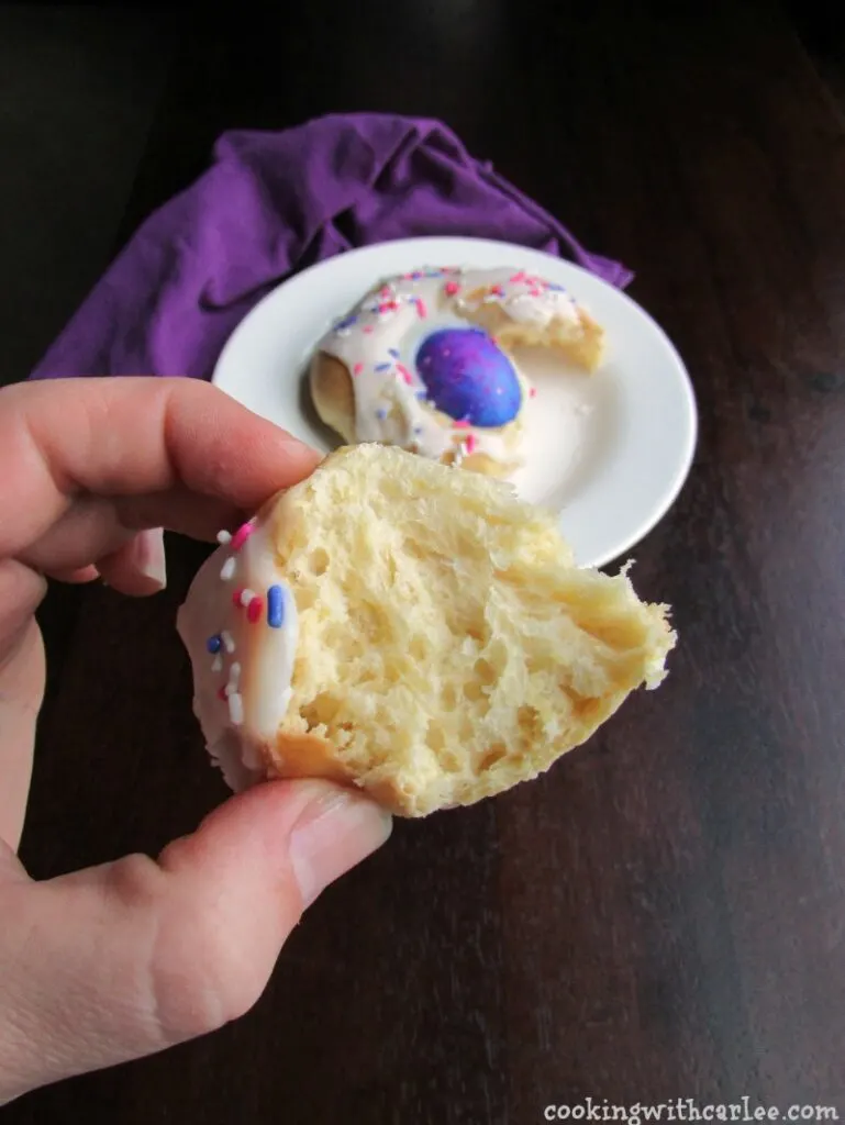 hand holding piece of easter bread with soft interior showing.