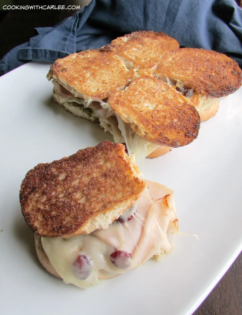 a turkey cranberry pesto and cheese slider pulled apart from the rest.