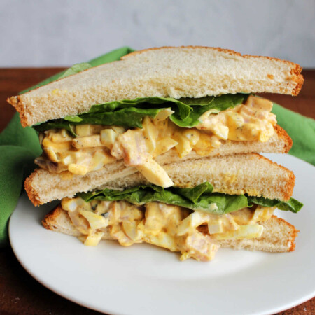 Deviled Ham and Egg Salad 2 Sandwich with whole wheat white bread, lettuce, and ham and egg salad cut in half.