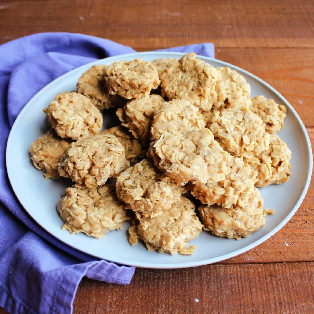 Serving plate loaded with no bake peanut butter cookies with oatmeal.