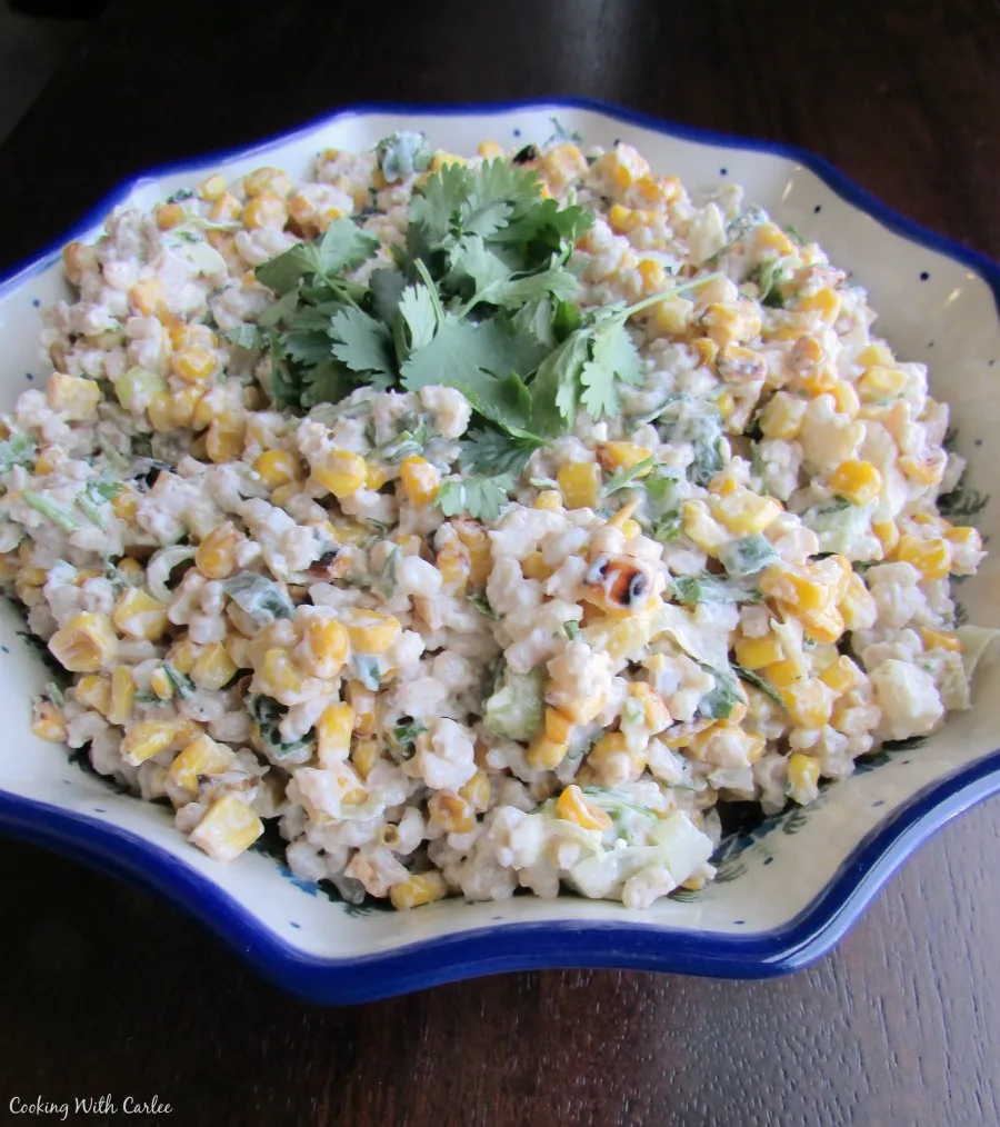 Serving bowl filled with pearled barley and corn salad topped with cilantro.