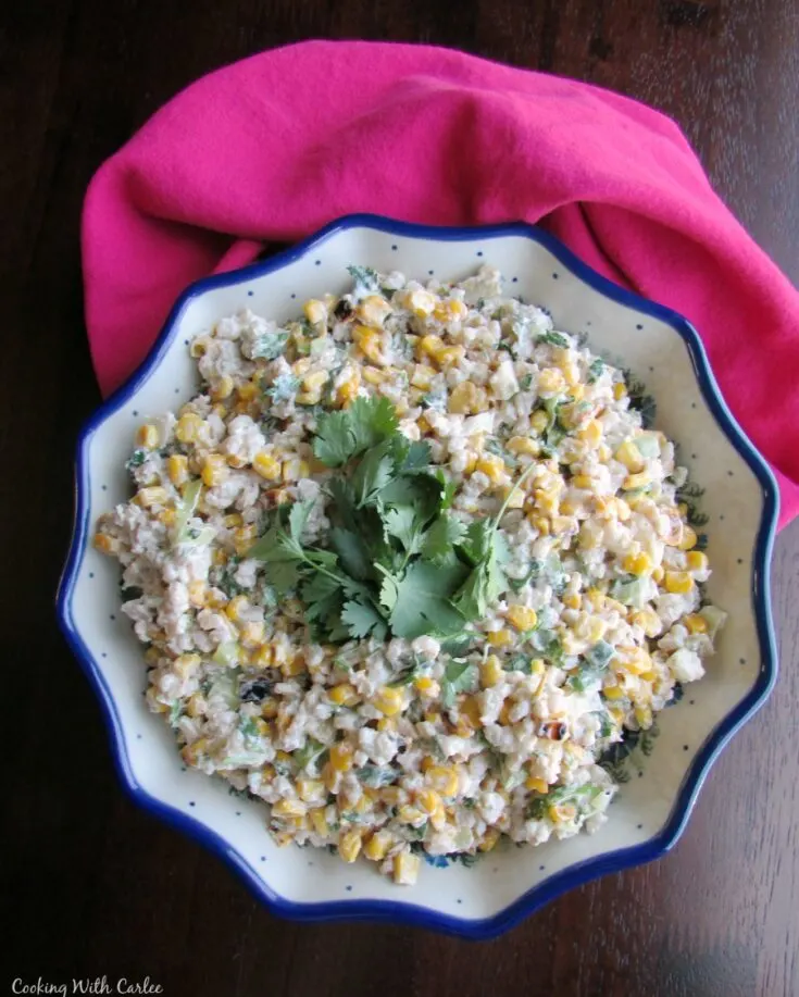 Serving bowl filled with Mexican corn and pearled barley salad ready to serve.