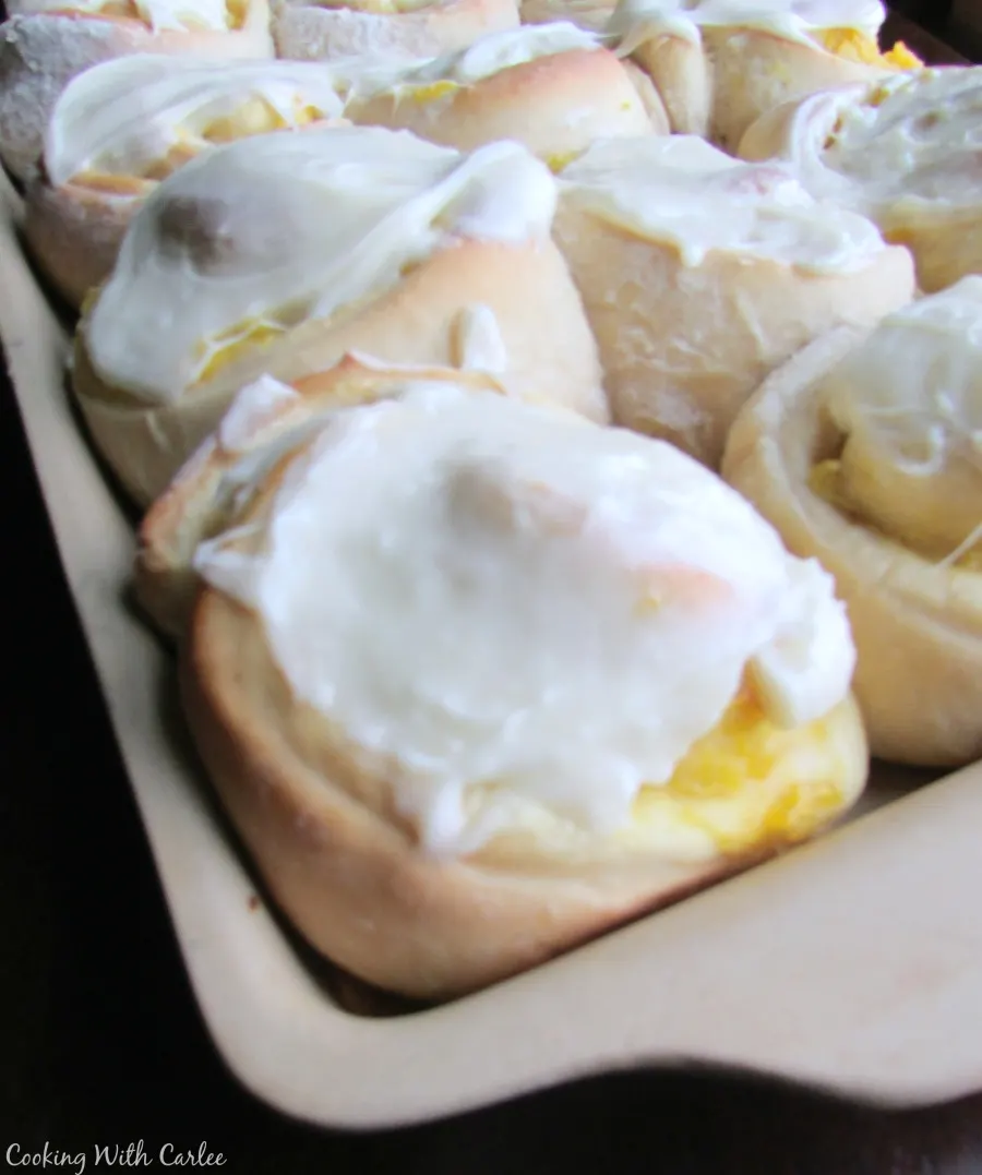 tray of pineapple breakfast rolls with vanilla frosting.