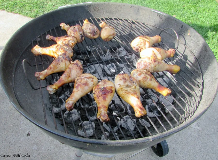 chicken drumsticks on charcoal grill.