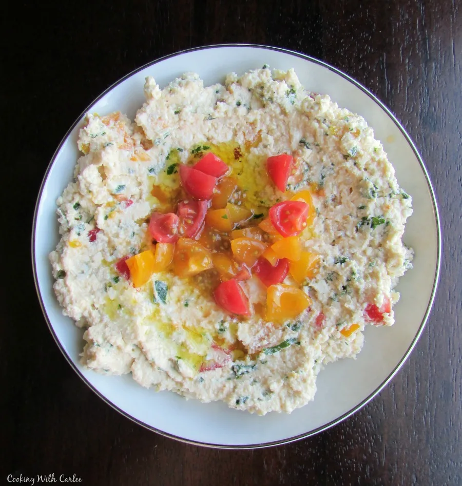 small bowl of feta mixed with herbs and tomatoes.