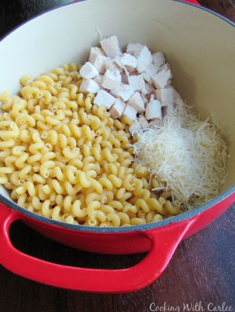 pasta cheese and chicken in pot.