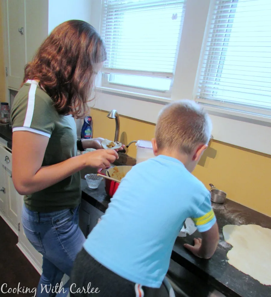 Chloe and Little Dude working on making cajeta empanadas