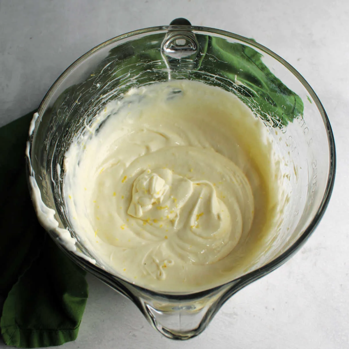 Mixing bowl filled with lemon, cream cheese and sweetened condensed milk pie filling.