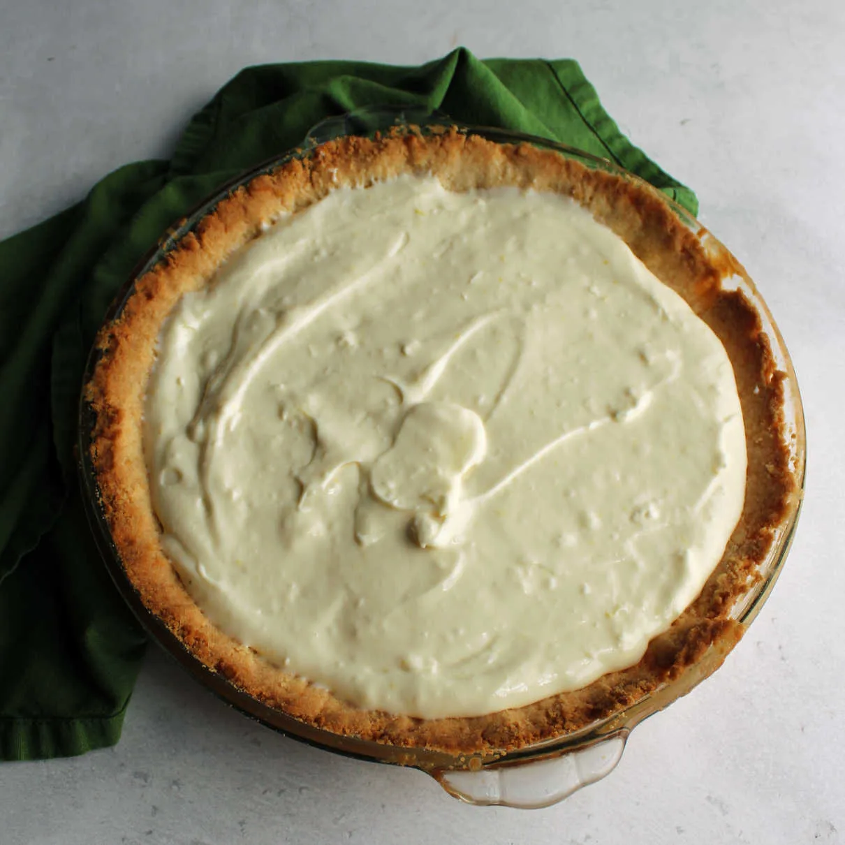 Lemon filling spread into cooled cookie pie crust.