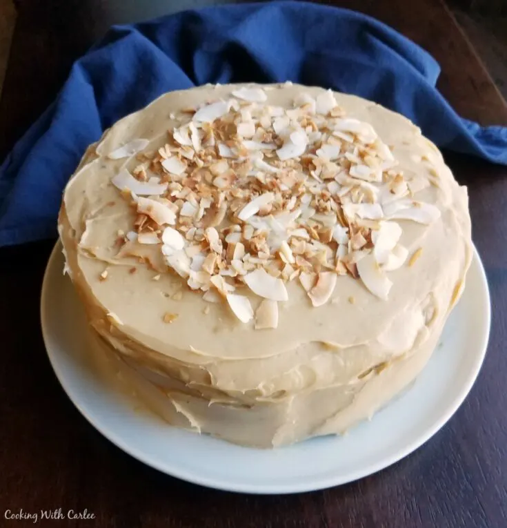 layer cake with sweetened condensed milk frosting topped with toasted coconut