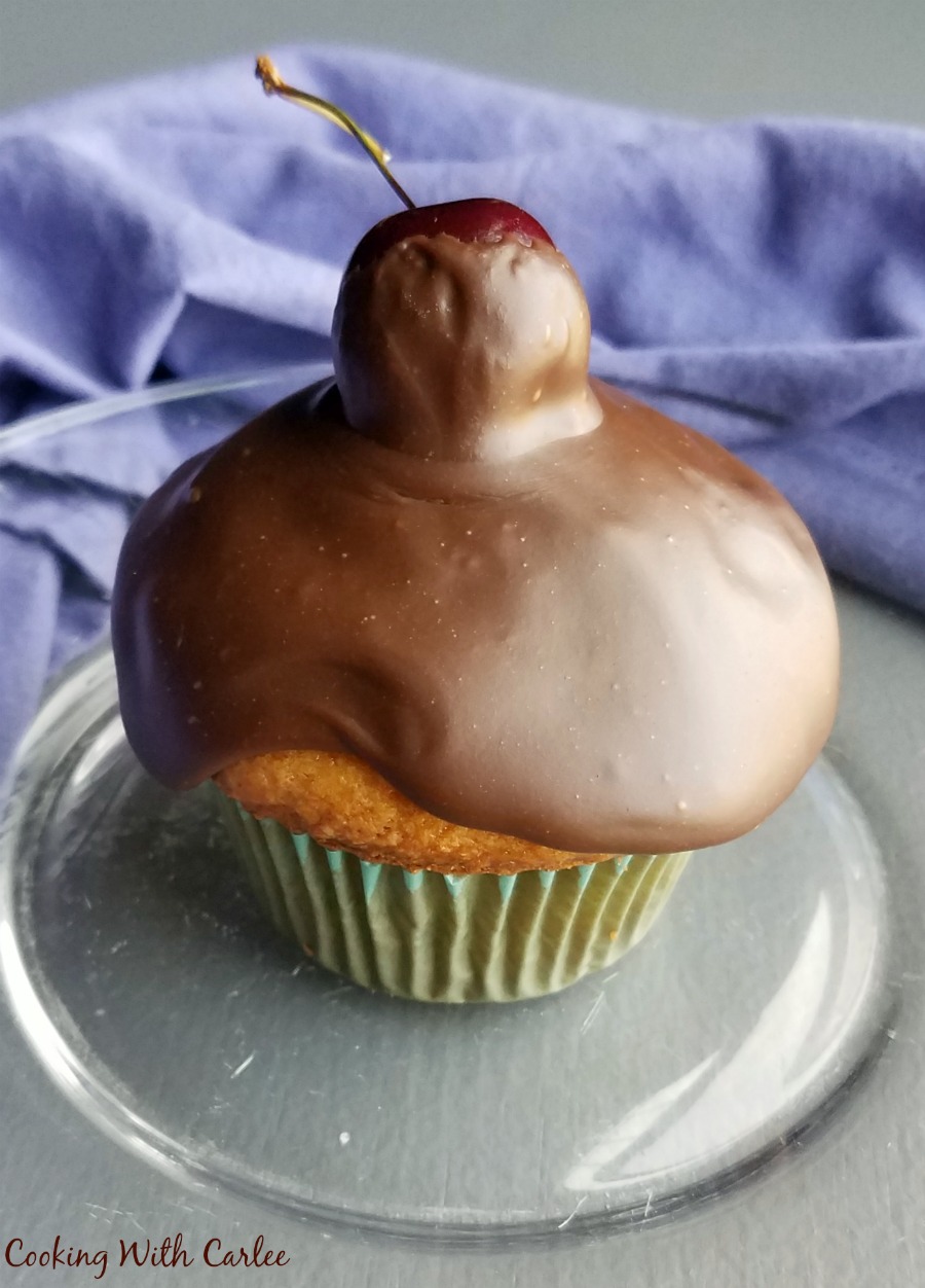 close up of chocolate topped cherry cupcake.