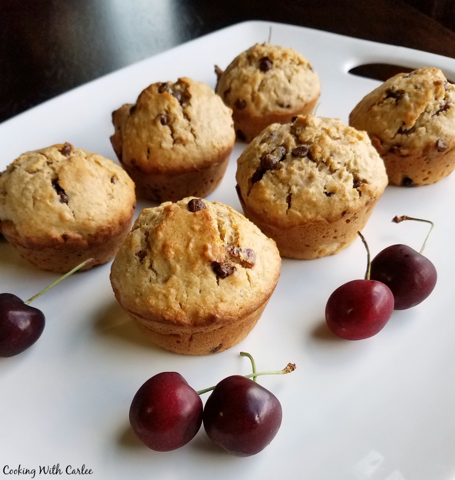 cherry chip muffins on platter with fresh sweet cherries