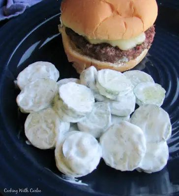creamy cucumber salad served with a hamburger