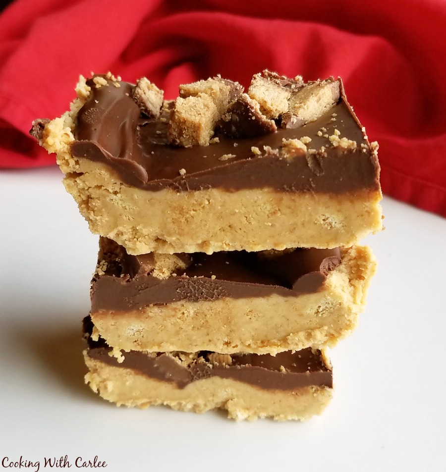 stack of no bake chocolate peanut butter bars with red napkin in background.