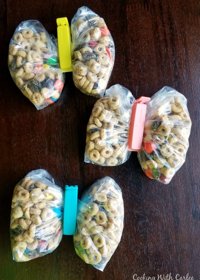 sandwich bags of peanut butter maple snack mix with bag clips down the center making them look like butterflies.