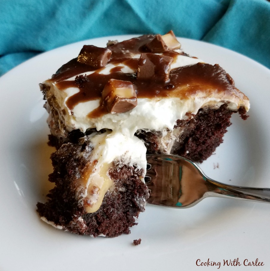 piece of rolo poke cake with boiled milk frosting