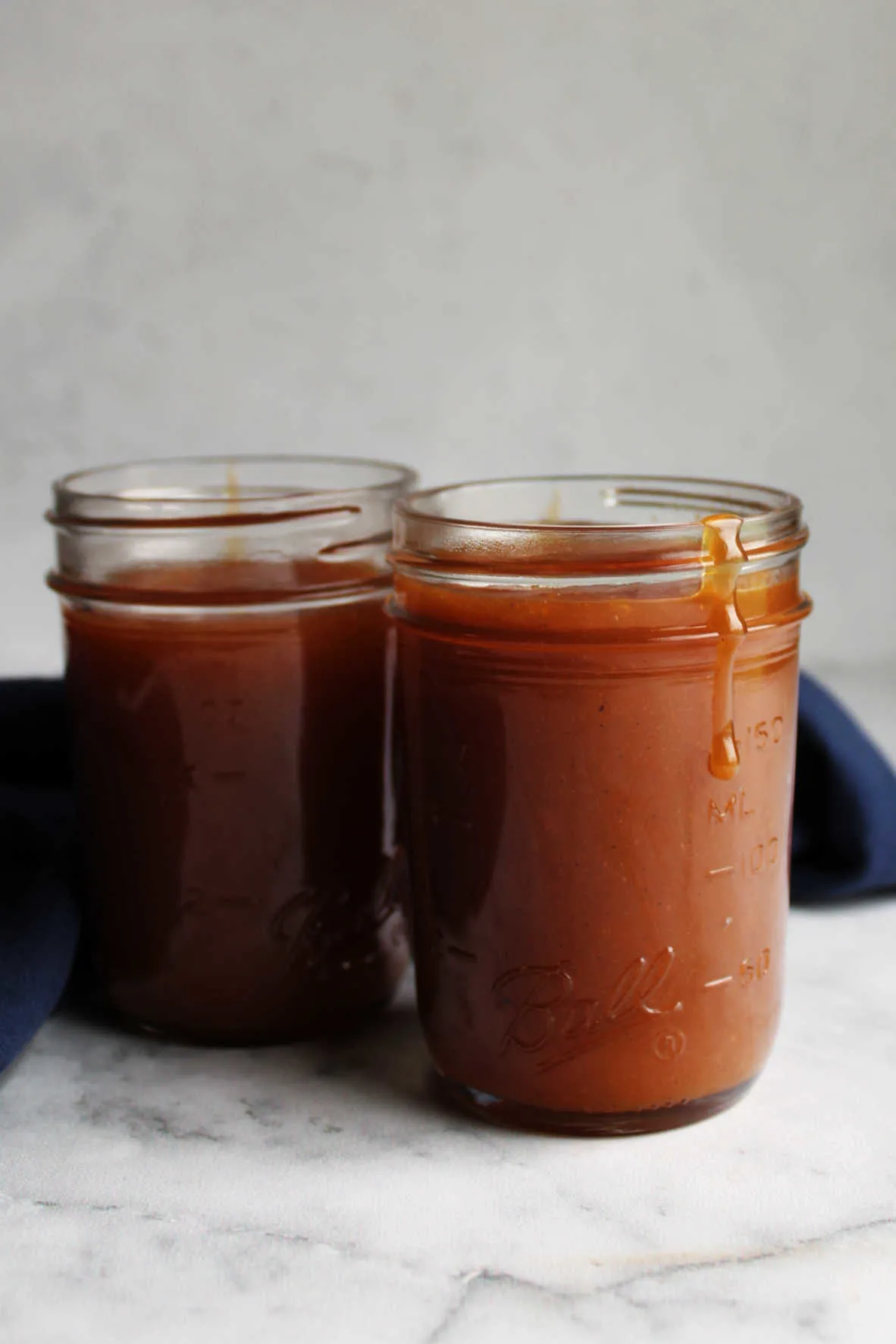 Jars of hot freshly made dulce de leche, ready to cool.