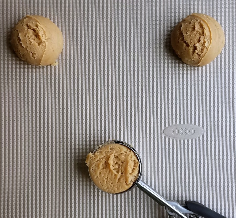 scoops of maple cinnamon cookie dough on cookie sheet getting ready to bake.