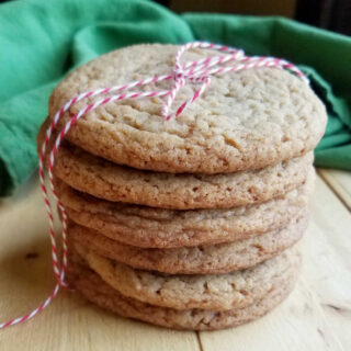 Stack of chewy maple cinnamon cookies tied up with red and white baker's twine.