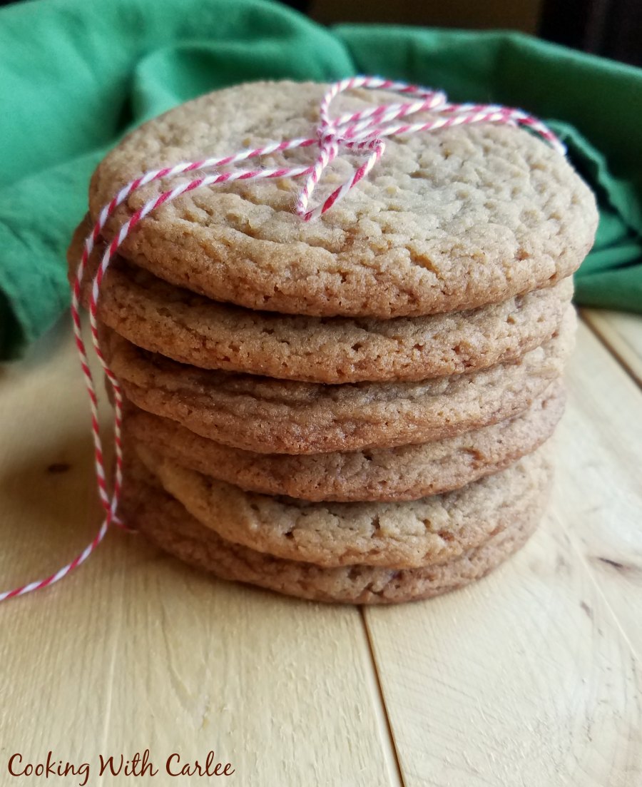 Stack of chewy maple cinnamon cookies tied up with red and white baker's twine
