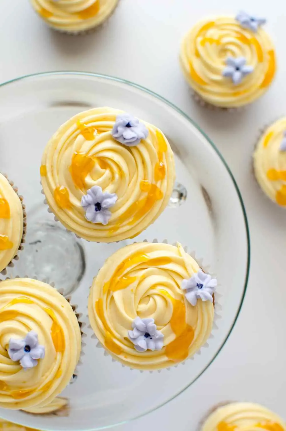 cupcakes topped with apricot frosting 