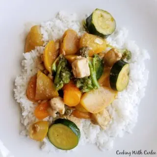 rice topped with chicken and veggie stir fry.