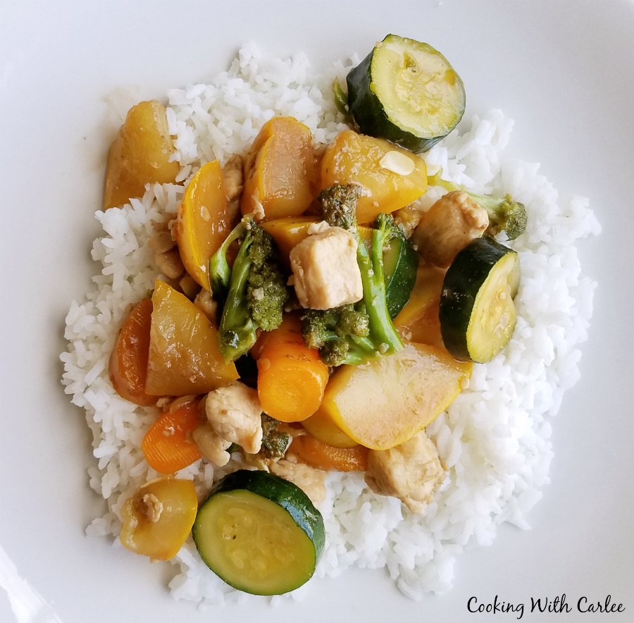 rice topped with chicken and veggie stir fry.