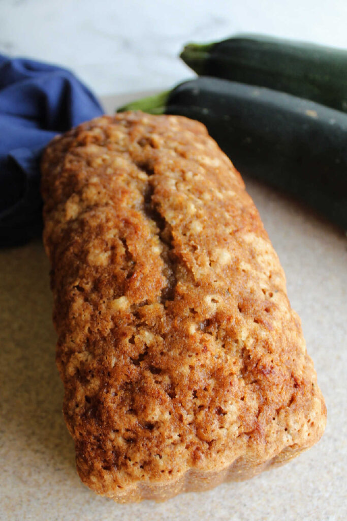 Whole loaf of zucchini bread with slightly crunchy top.