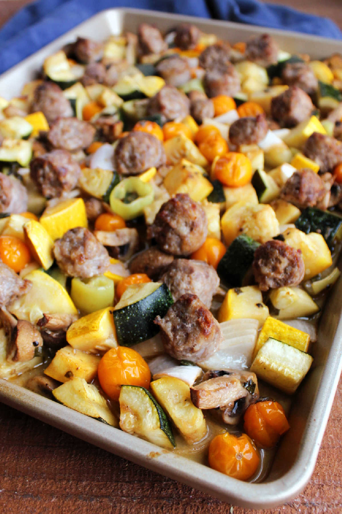 Sheet pan of roasted vegetables and Italian sausage fresh from the oven. 