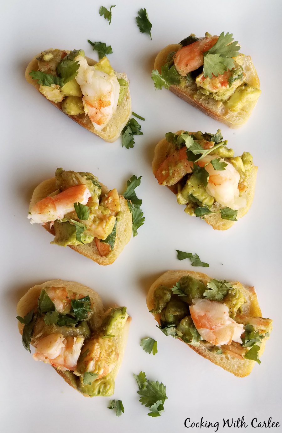 shrimp and avocado toast appetizers on platter.