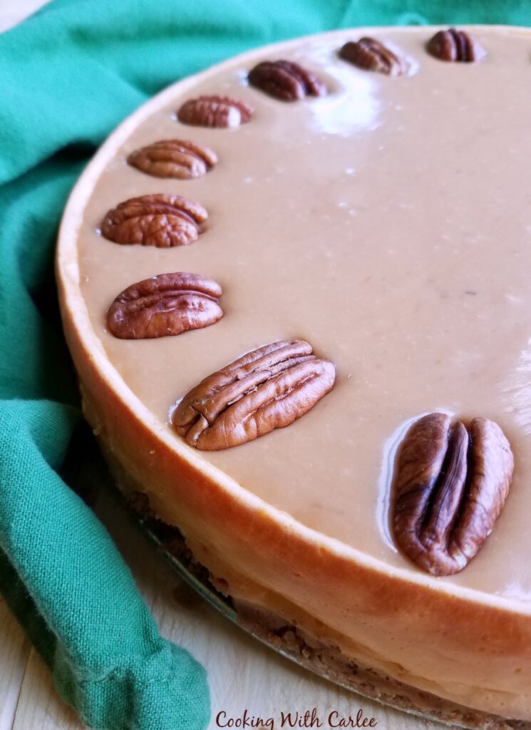 close up of caramel and pecan topped cheesecake.