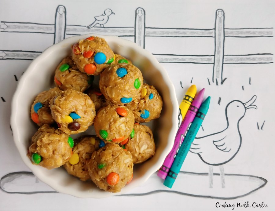 bowl of monster cookie dough bites over duck coloring page with crayons.